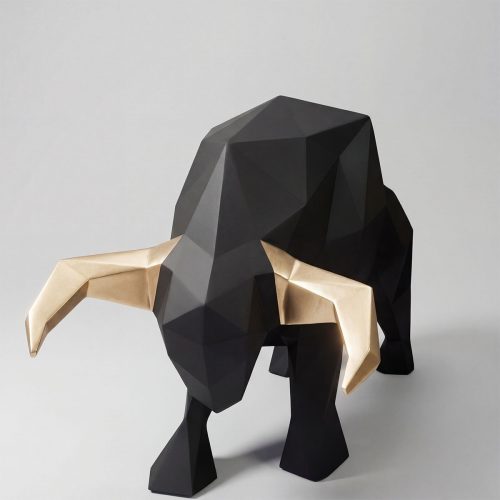 sculpture bull figure in black geometric fiberglass with metallic gold horns for advertising or modern interior decor