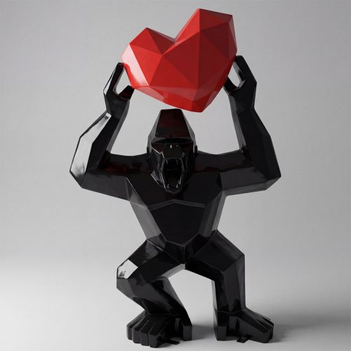 sculpture gorilla holding a faceted red heart, black glossy geometric fiberglass figure for decor or advertising