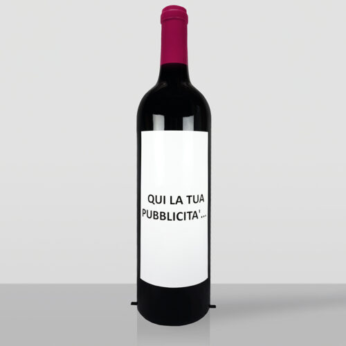 Large decorative wine bottle with a label reading 'Vineria Carin Wine & Restaurant' standing outside a building next to a wooden door and two wooden wine barrels on a cobblestone street.