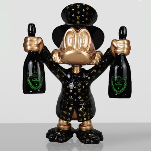Glossy black and gold sculpture of a cartoon duck character wearing a Louis Vuitton patterned suit and top hat, holding a bottle of champagne in each hand against a plain light gray background.