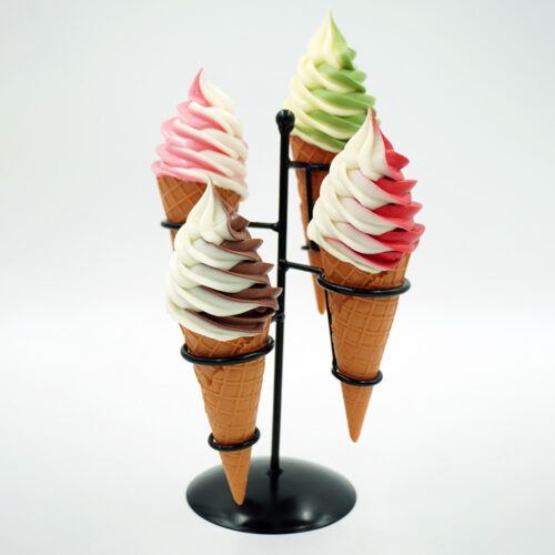 Four soft-serve ice cream cones in a black metal holder, each with swirled flavors: chocolate and vanilla, strawberry and vanilla, green tea and vanilla, and raspberry and vanilla, against a plain white background.