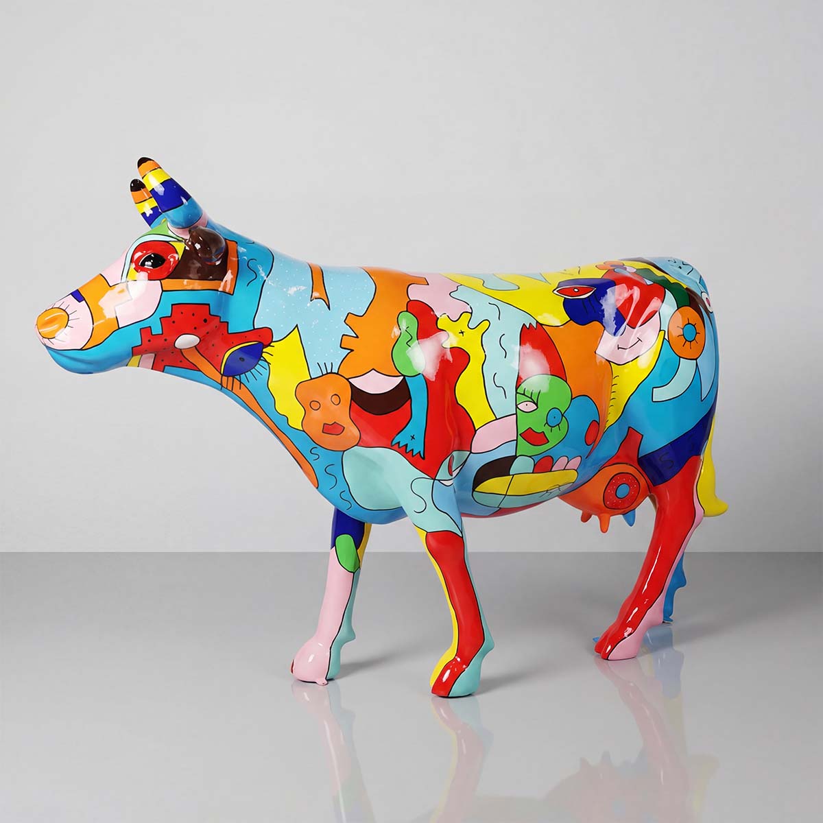 figure cow sculpture in glossy fiberglass with colorful abstract pop-art patterns, ideal for mall or event advertising