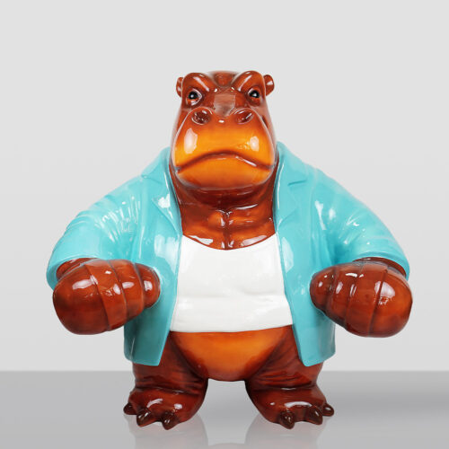 Glossy ceramic figurine of a hippo wearing a white tank top and turquoise jacket, standing with arms bent forward against a plain light gray background.