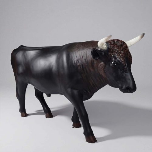 figure bull sculpture in dark brown fiberglass with white horns, realistic style for advertising or mall decor