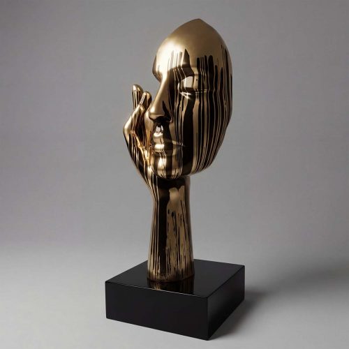 sculpture head figure in gold-tone fiberglass with dripped black stripe pattern, stylized hand supporting face for decor or advertising