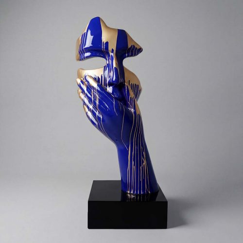 sculpture face and hand figure in glossy blue and gold fiberglass, abstract artistic style for interior decor or advertising