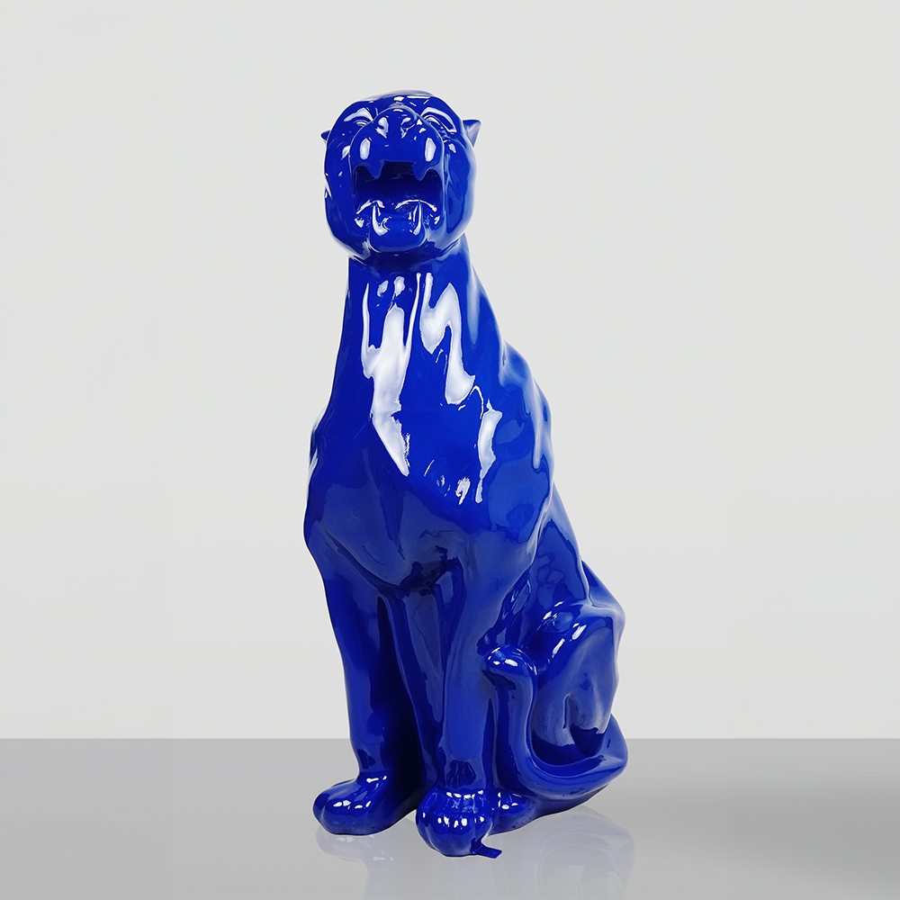 Black glossy ceramic figurine of a sitting panther on a white background.
