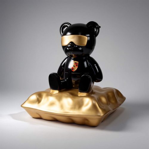 Porsche Teddy Bear sitting on a pillow