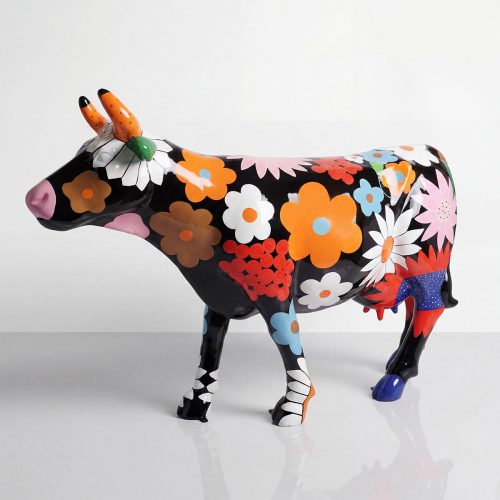 figure cow sculpture in glossy fiberglass with bright floral pop-art pattern, black base for mall decor or event advertising