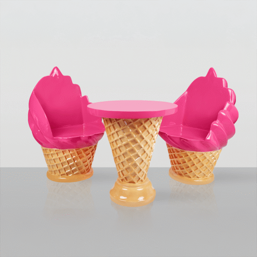 A whimsical furniture set consisting of a table and four chairs designed to look like ice cream cones with white swirl ice cream tops, on a reflective surface against a plain light gray background.