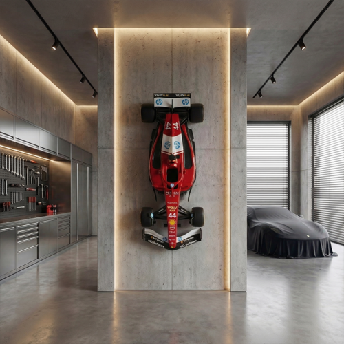 fiberglass figure of a red Formula 1 car mounted vertically on concrete wall, glossy racing-style decor for garage or showroom