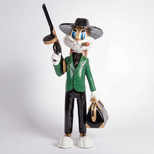figure rabbit sculpture in glossy fiberglass, green patterned jacket, black hat and trousers, holding bag and tommy gun, decorative display