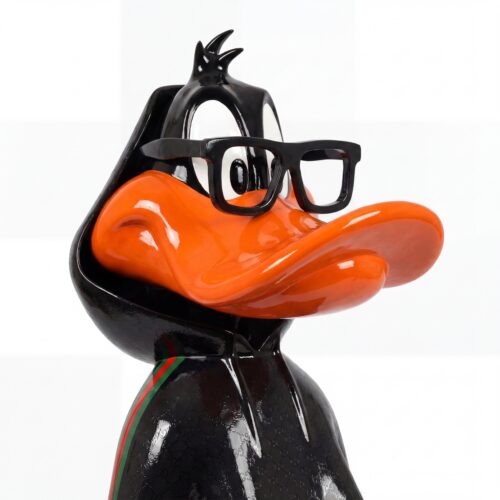 sculpture duck figure in glossy black fiberglass with oversized orange beak and black glasses, modern decorative display use