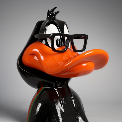 figure Daffy Duck sculpture in glossy black fiberglass with orange beak, streetwear style hoodie and sneakers for advertising interior decor