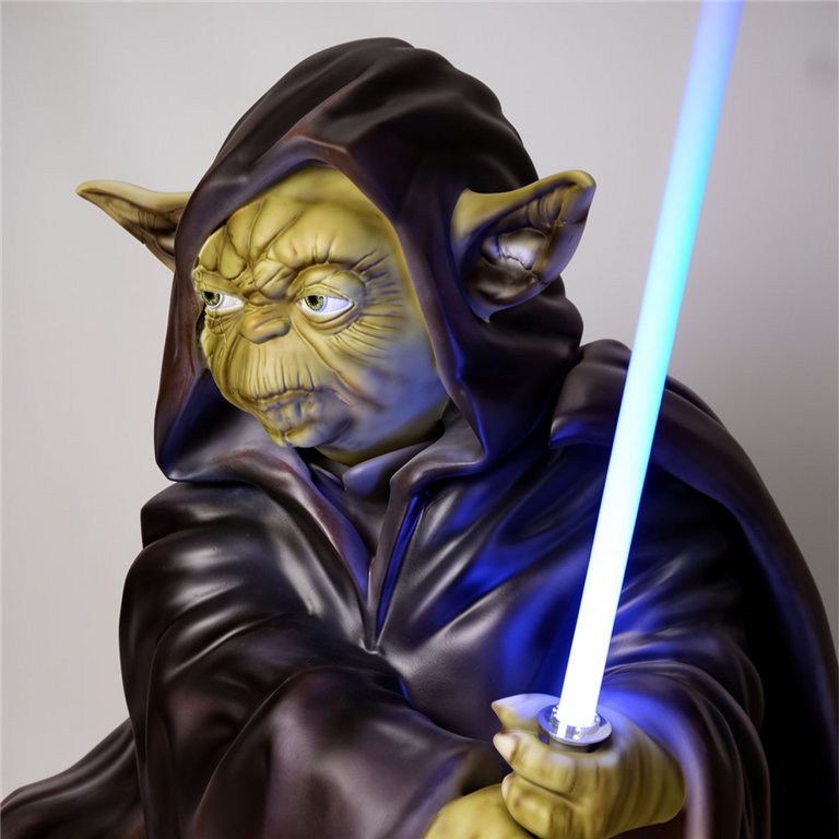 sculpture Yoda-like figure in fiberglass with green wrinkled face, dark hooded robe and blue lightsaber for display or advertising